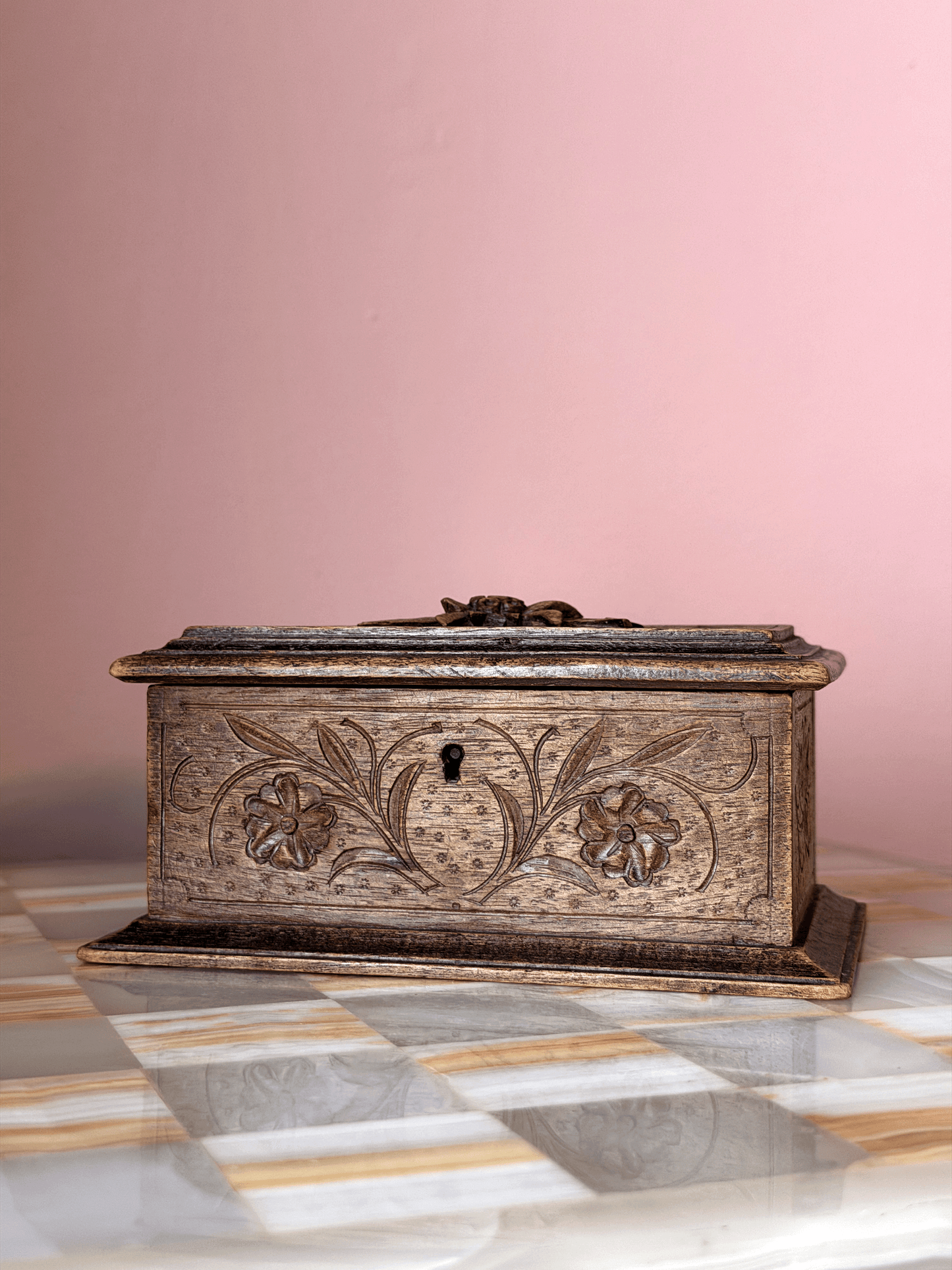 Antique late 19th-century Swiss Alpine folk art wood trinket box, showcasing extensive chip-carving, notched geometric borders, and a tiered molding base