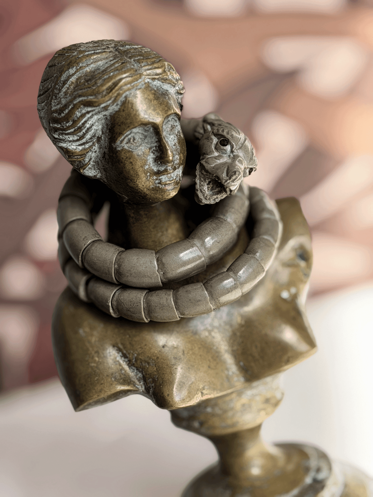 Antique Victorian Vesuvius lava stone snake wrap bracelet draped on the neck of a classical bronze female bust