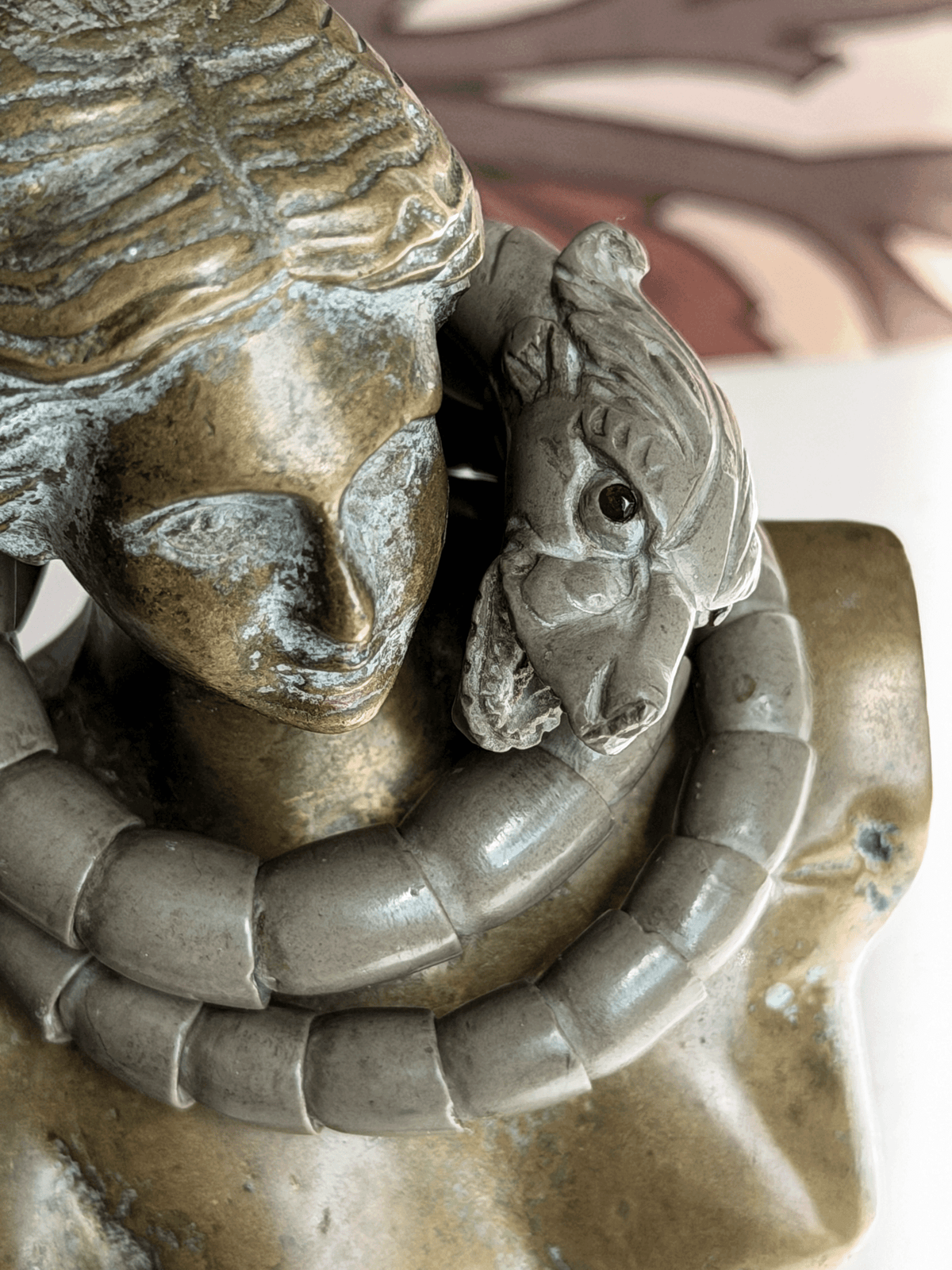 Antique Victorian Vesuvius lava stone snake wrap bracelet draped on the neck of a classical bronze female bust