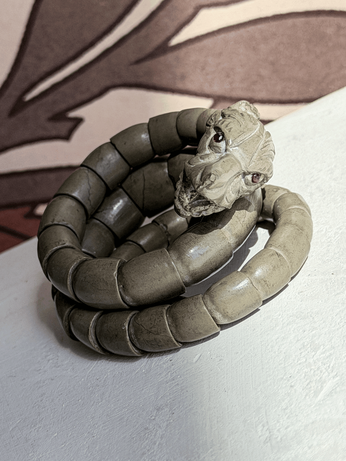 Pristine 19th century carved volcanic rock articulated serpent coil bracelet with real rubies