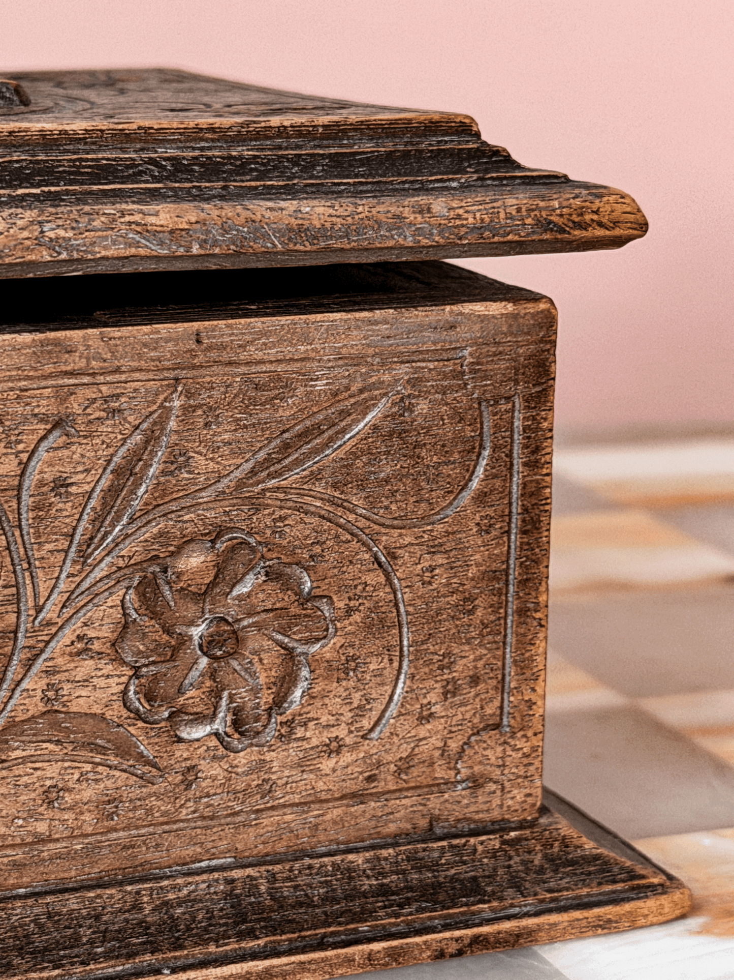 Antique late 19th-century Swiss Alpine folk art wood trinket box, showcasing extensive chip-carving, notched geometric borders, and a tiered molding base 