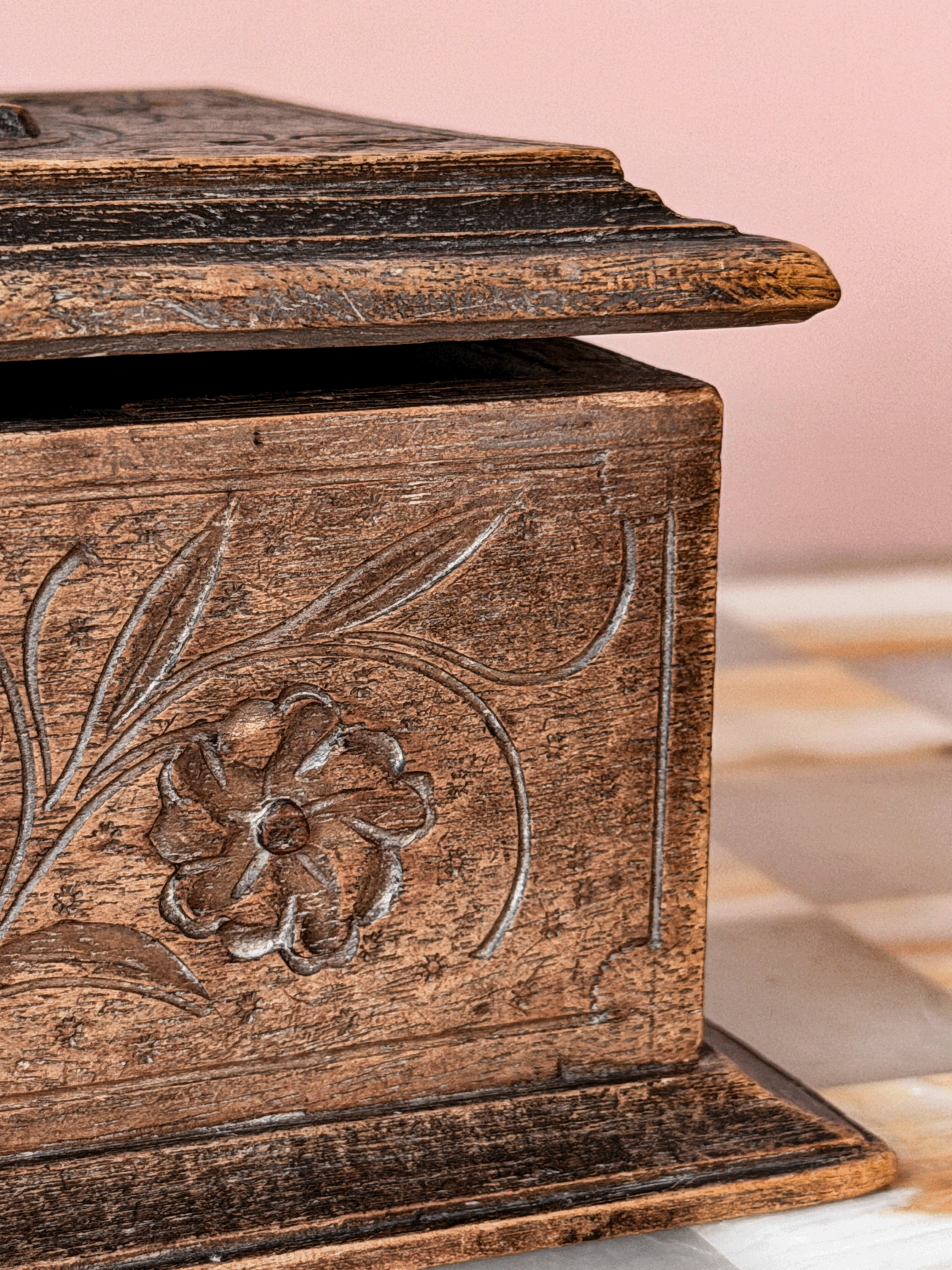Antique late 19th-century Swiss Alpine folk art wood trinket box, showcasing extensive chip-carving, notched geometric borders, and a tiered molding base 