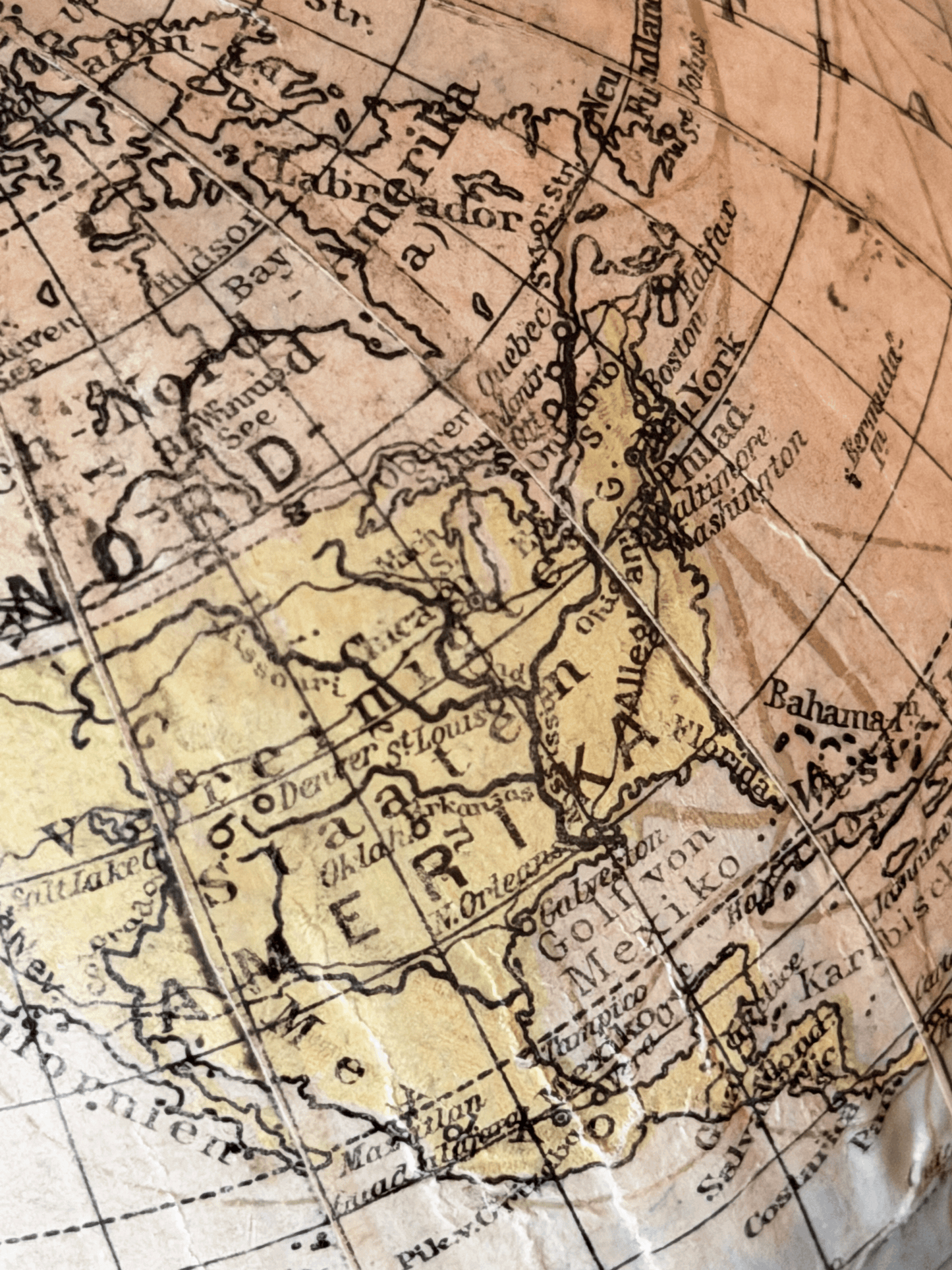 Close-up of interwar cartography on a 1920s German paper globe, showing detailed Weimar-era geography with labels for Leningrad, Scandinavia, and Sowj. Rußl. in a clean serif typography.