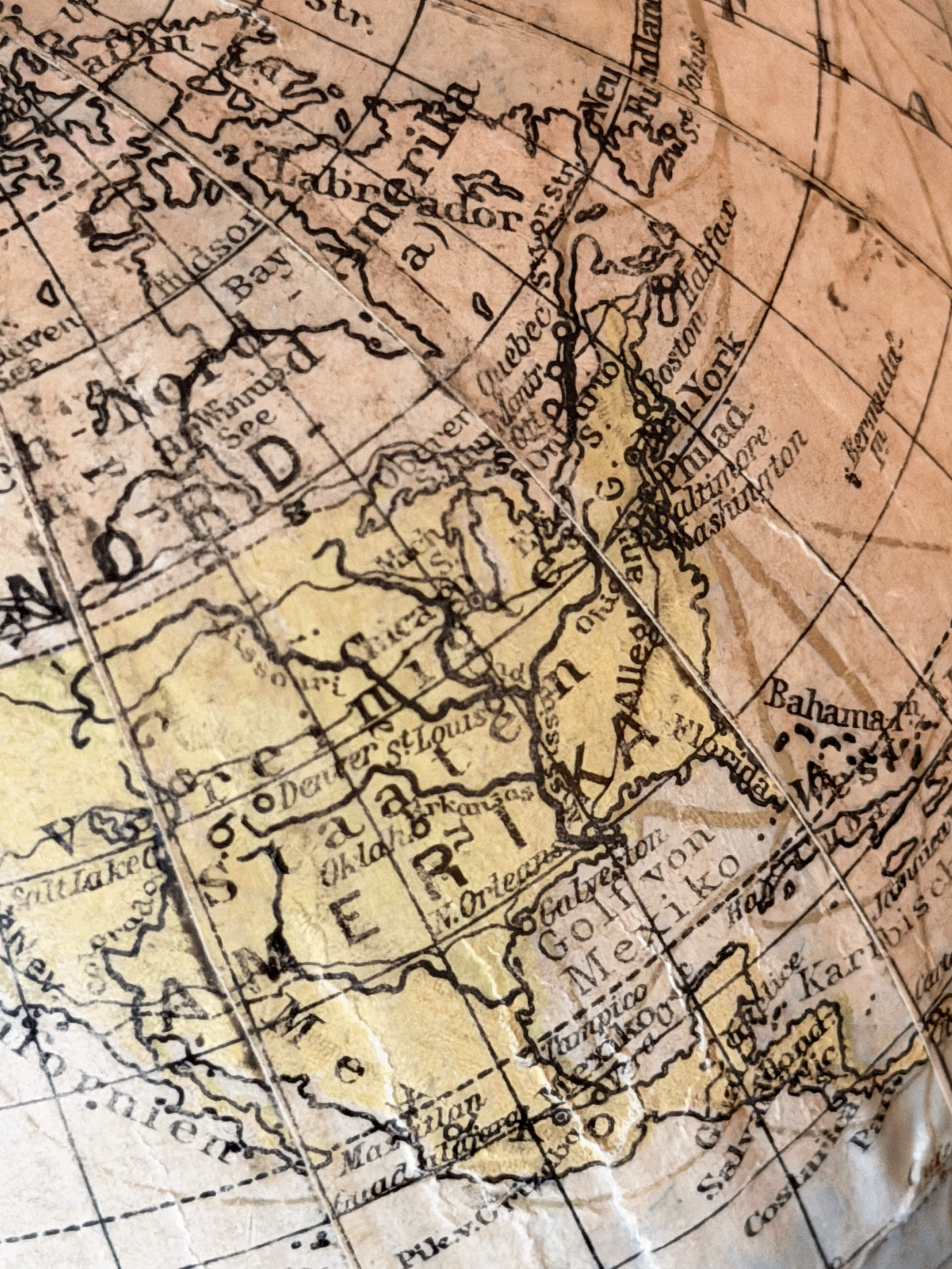 Close-up of interwar cartography on a 1920s German paper globe, showing detailed Weimar-era geography with labels for Leningrad, Scandinavia, and Sowj. Rußl. in a clean serif typography.
