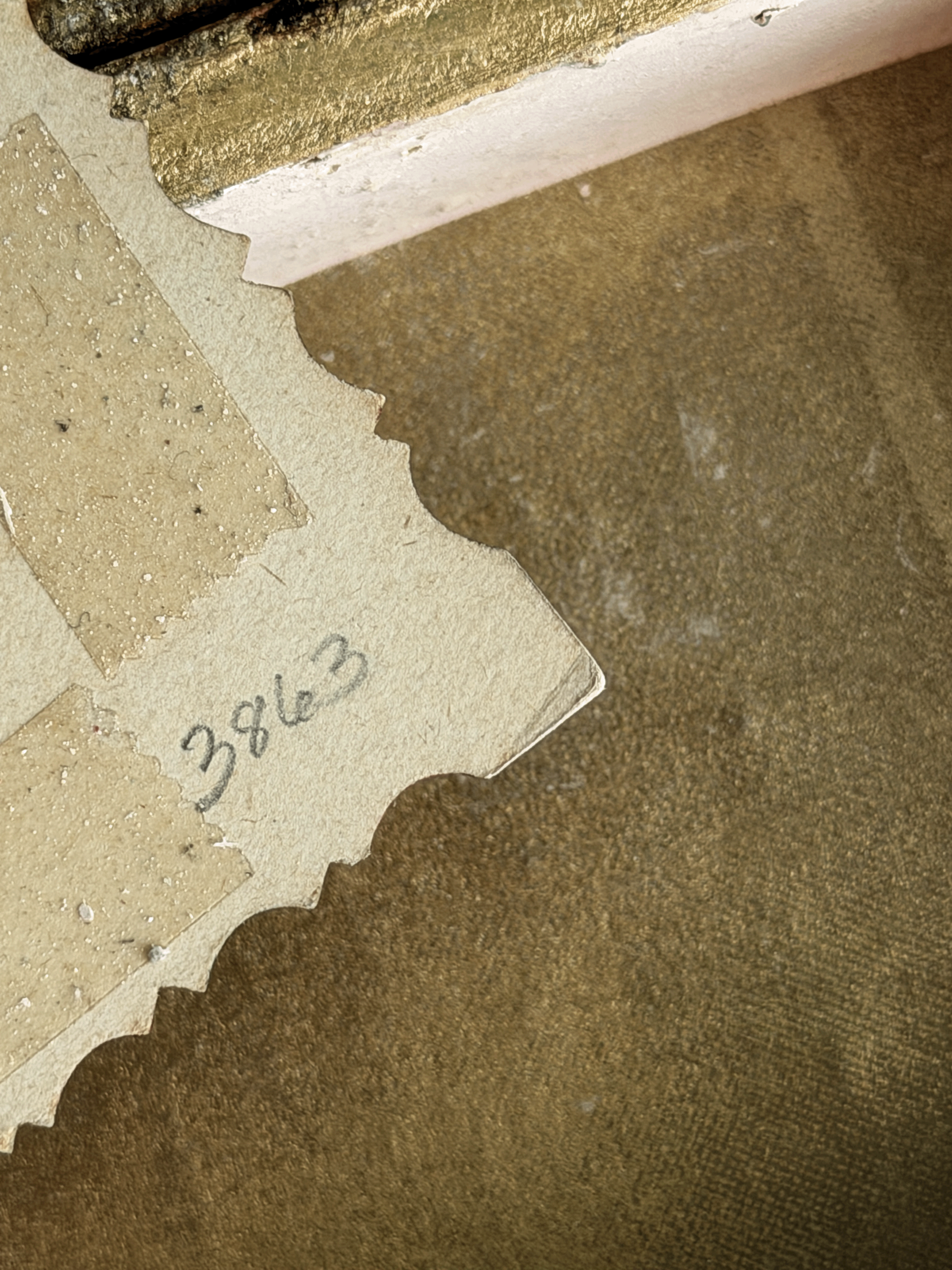 Reverse side of a vintage 19th-century paper calling card showing handwritten stock catalog number 3863 in pencil, surrounded by tan-colored adhesive glue stains from an old scrapbook album.