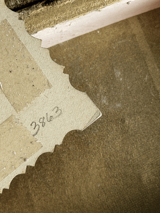 Reverse side of a vintage 19th-century paper calling card showing handwritten stock catalog number 3863 in pencil, surrounded by tan-colored adhesive glue stains from an old scrapbook album.