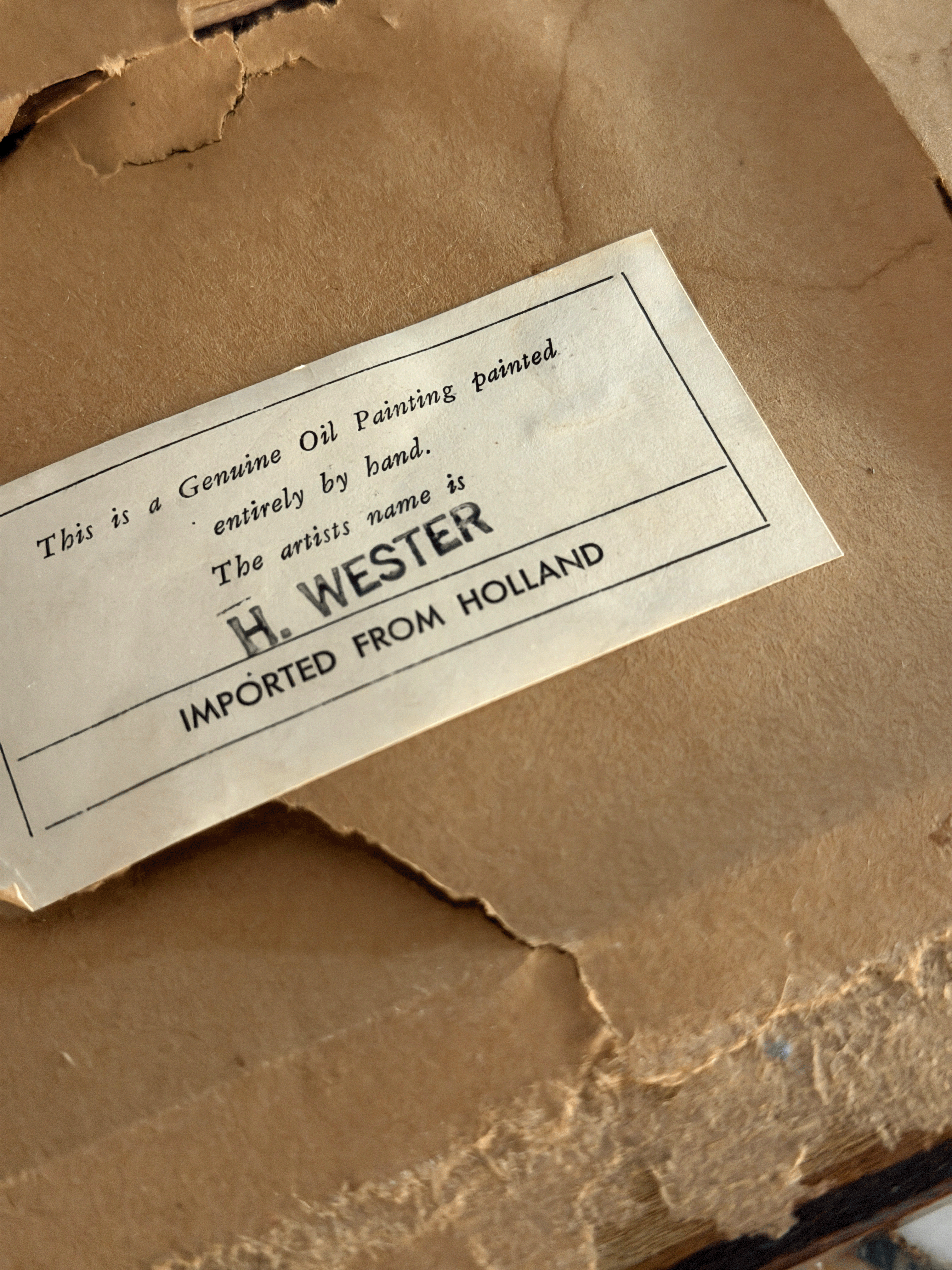 Backing paper of a vintage framed maritime painting showing an authentic typed importer label with ink-stamped text reading H. WESTER and GENUINE OIL PAINTING HAND PAINTED IMPORTED FROM HOLLAND.