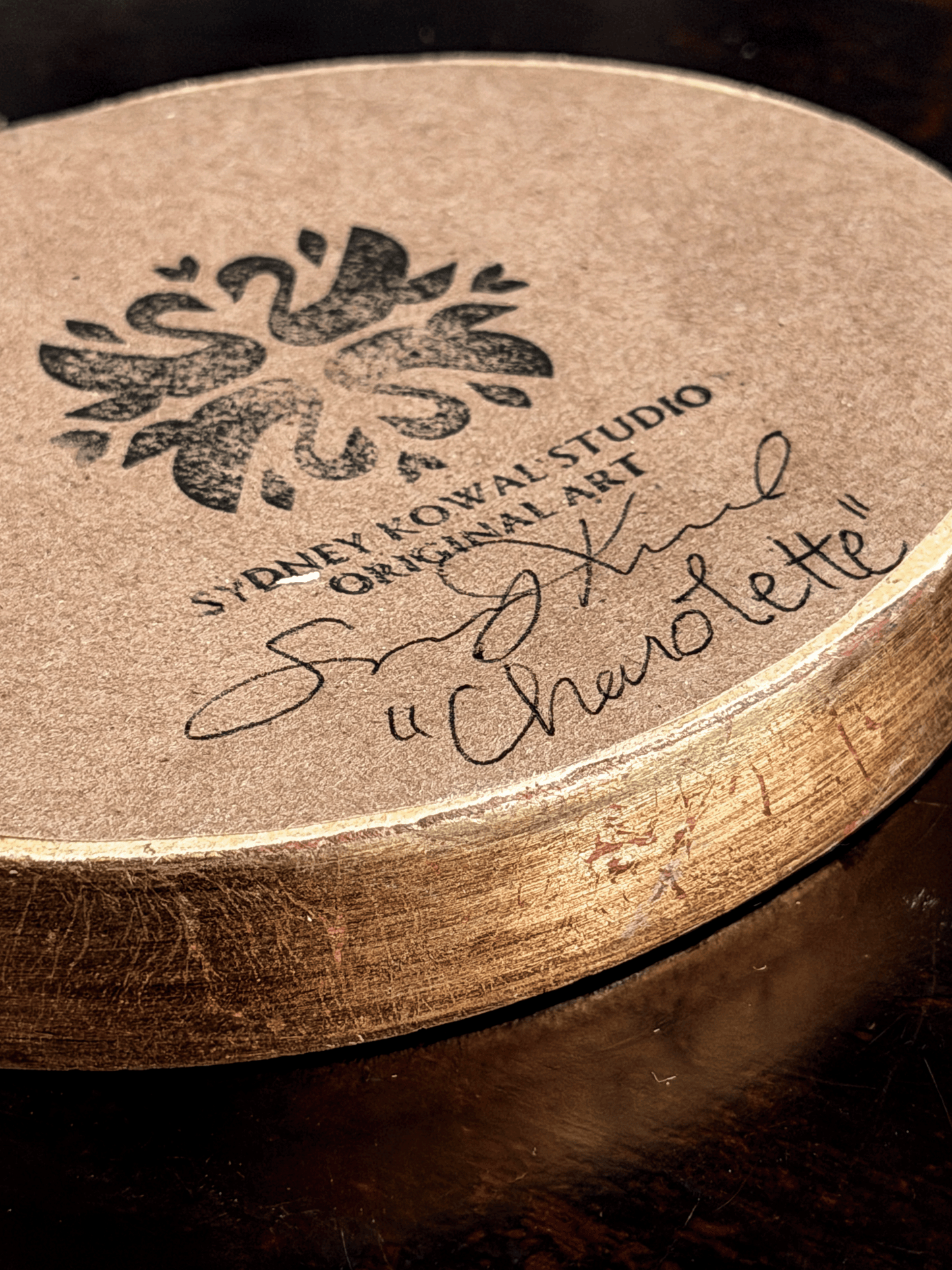 artist artwork authenticity stamp, signature and piece name on back of original artwork. features signature by artist Sydney Kowal with the title of name of subject "Charolette" 