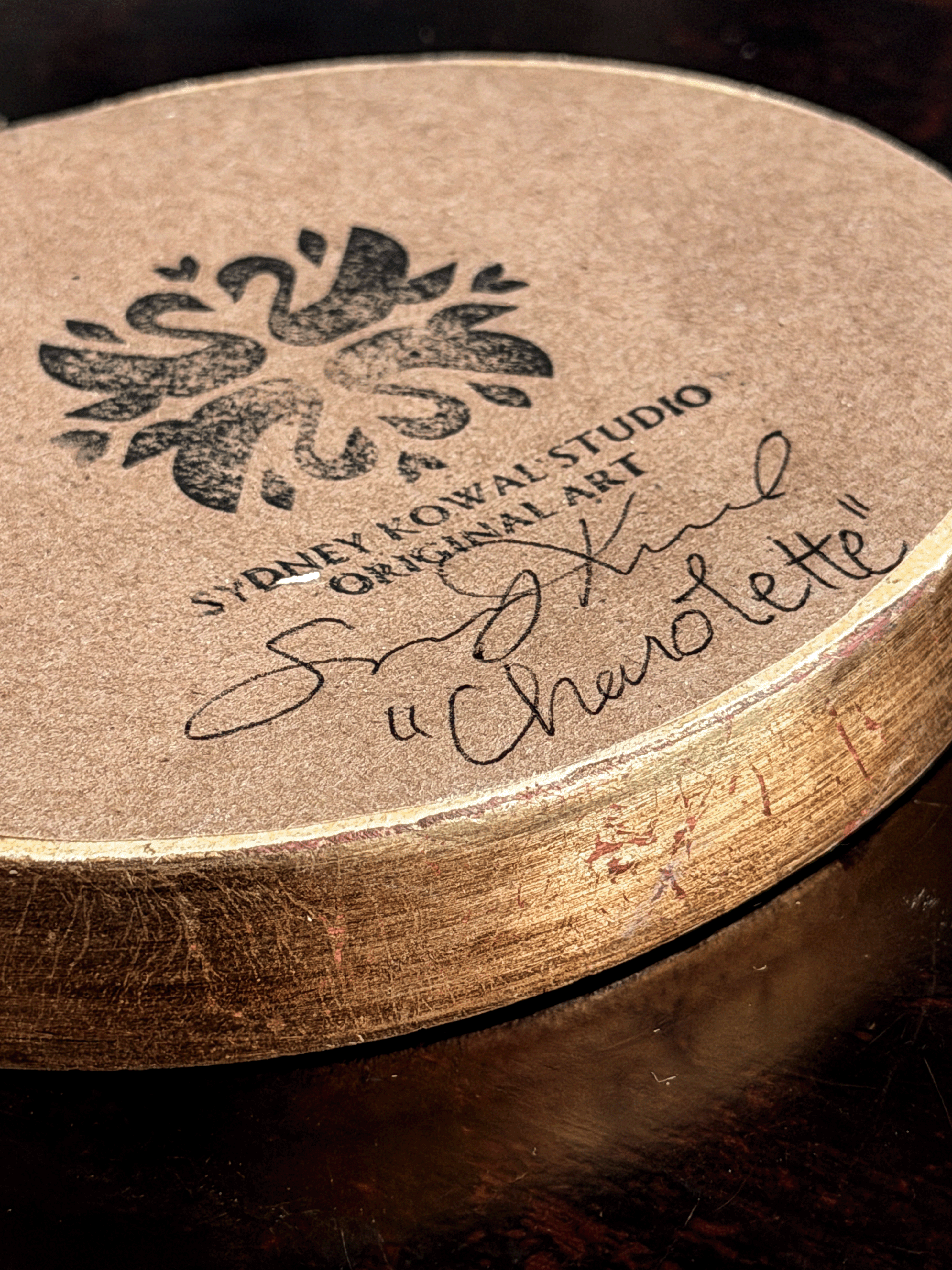 artist artwork authenticity stamp, signature and piece name on back of original artwork. features signature by artist Sydney Kowal with the title of name of subject "Charolette" 