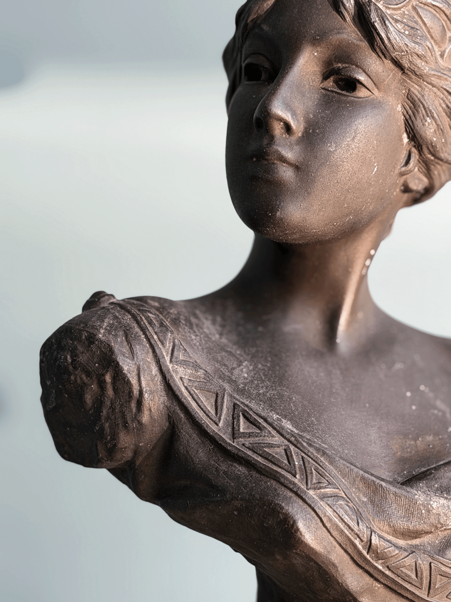 Antique Art Nouveau dark bronze spelter bust sculpture of the Greek goddess Circe with decorative coin headdress.