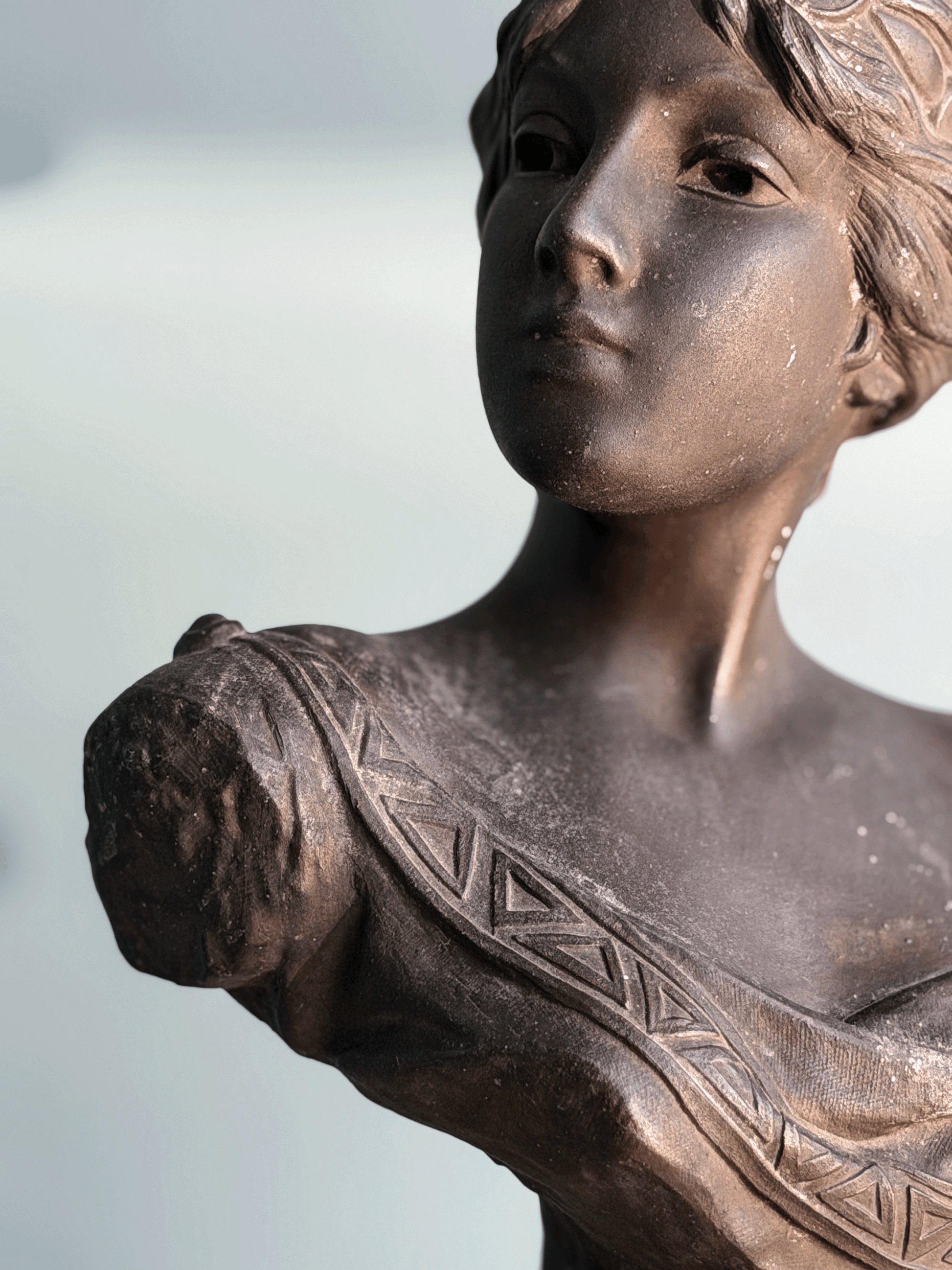 Antique Art Nouveau dark bronze spelter bust sculpture of the Greek goddess Circe with decorative coin headdress.