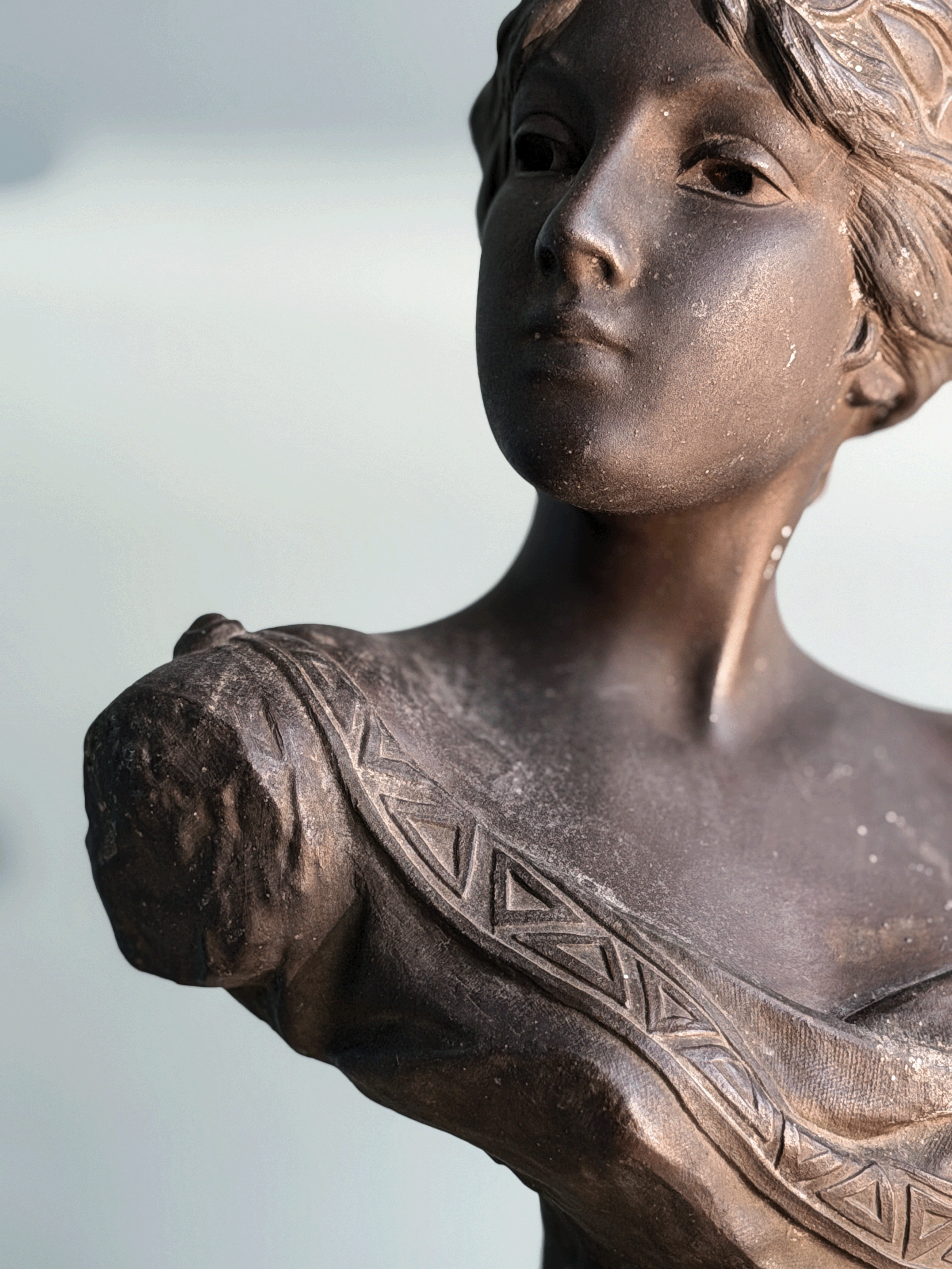 Antique Art Nouveau dark bronze spelter bust sculpture of the Greek goddess Circe with decorative coin headdress.