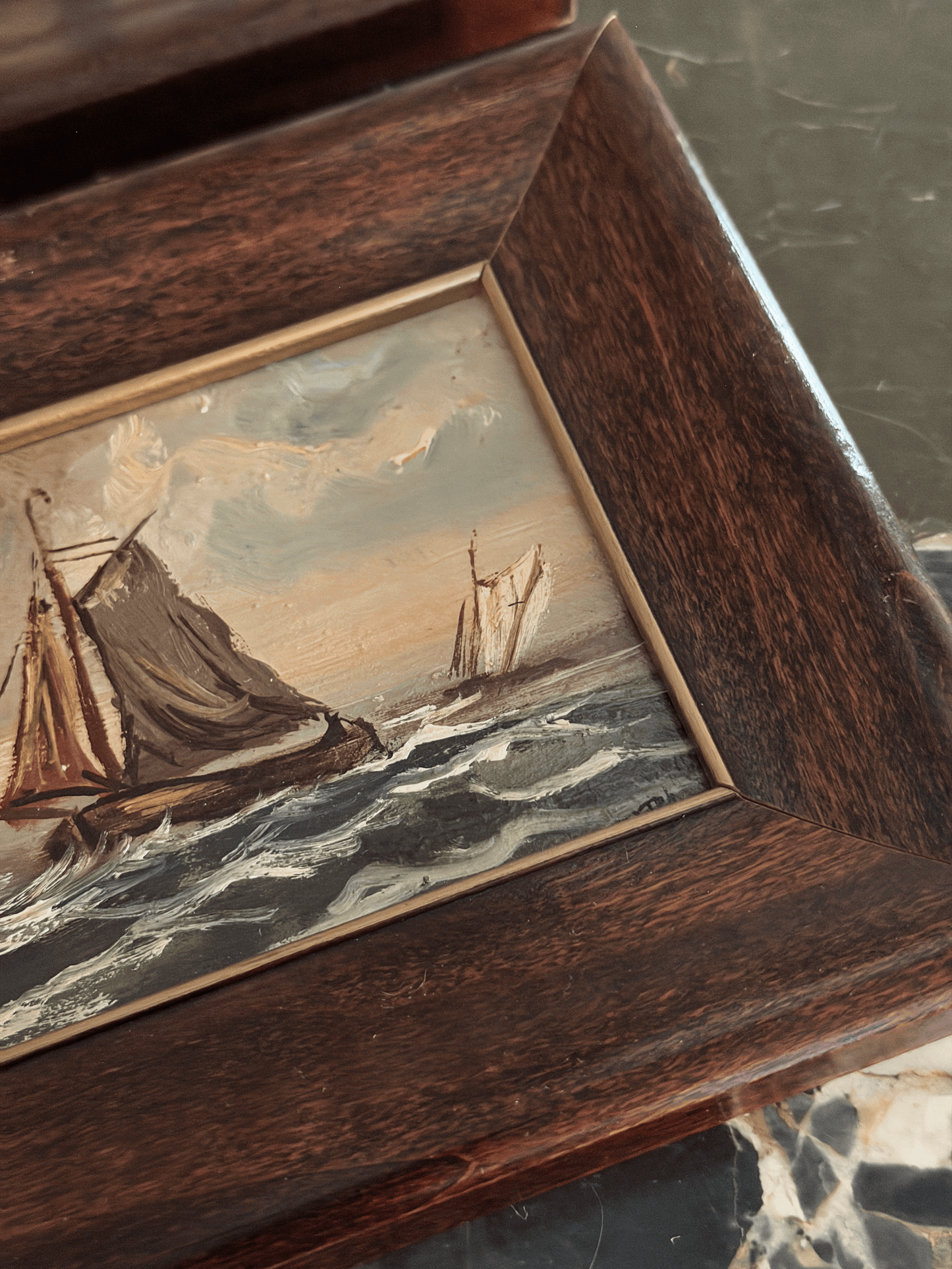 Cohesive pair of vintage miniature nautical oil paintings on board signed by Dutch artist H. Wester in 1984, depicting a white-sailed yacht and a dark-sailed fishing barge in rough ocean waves, housed in matching beveled walnut frames with gold fillets.