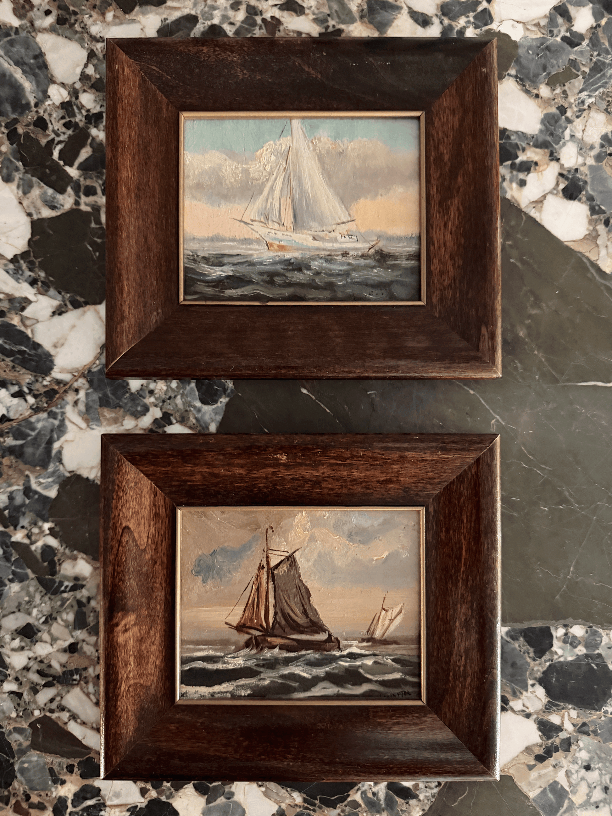 Cohesive pair of vintage miniature nautical oil paintings on board signed by Dutch artist H. Wester in 1984, depicting a white-sailed yacht and a dark-sailed fishing barge in rough ocean waves, housed in matching beveled walnut frames with gold fillets.
