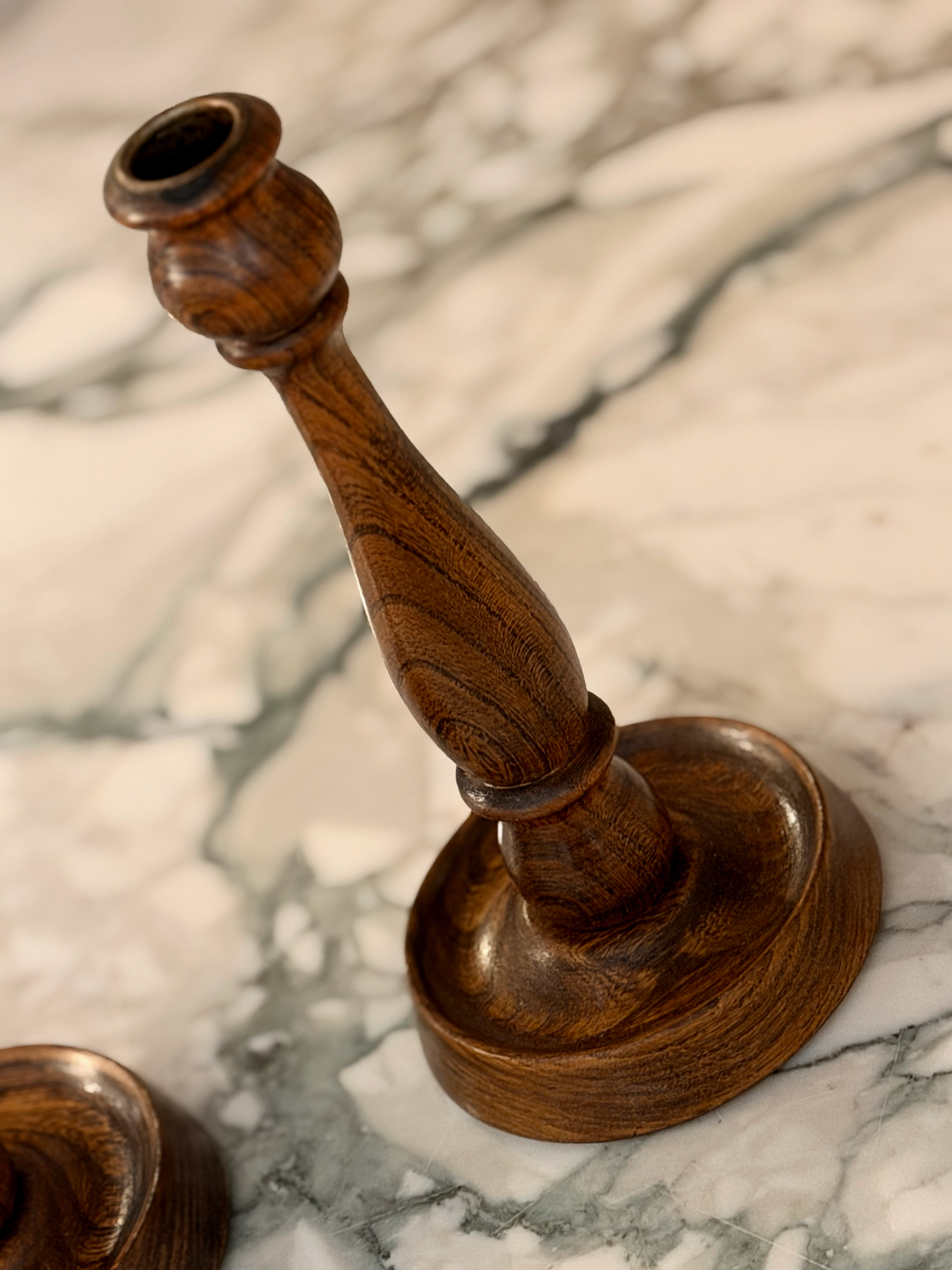 Wooden candle holder on a marble surface