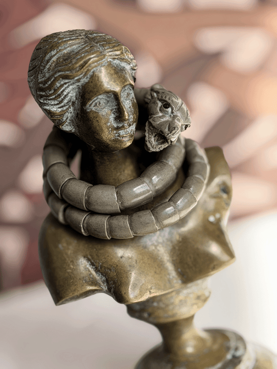 Antique Victorian Vesuvius lava stone snake wrap bracelet draped on the neck of a classical bronze female bust