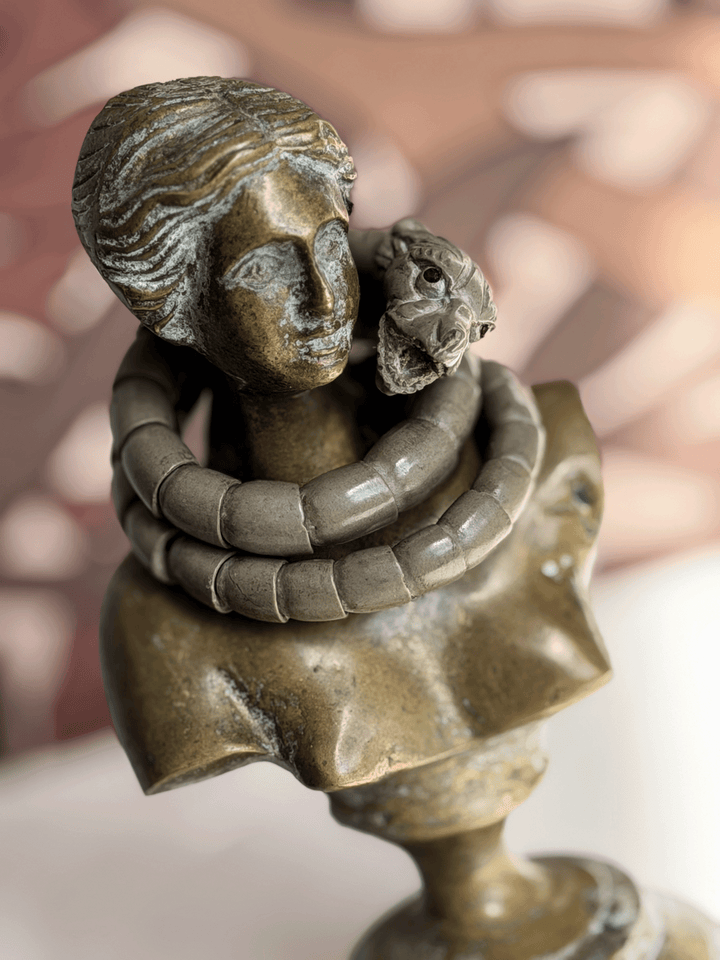 Antique Victorian Vesuvius lava stone snake wrap bracelet draped on the neck of a classical bronze female bust