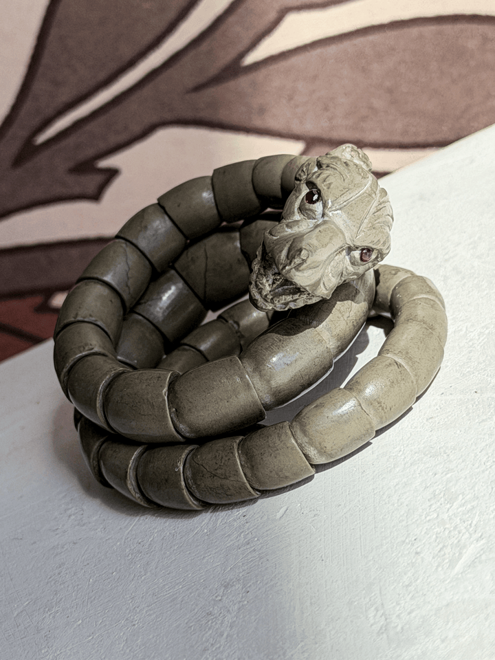 Pristine 19th century carved volcanic rock articulated serpent coil bracelet with real rubies