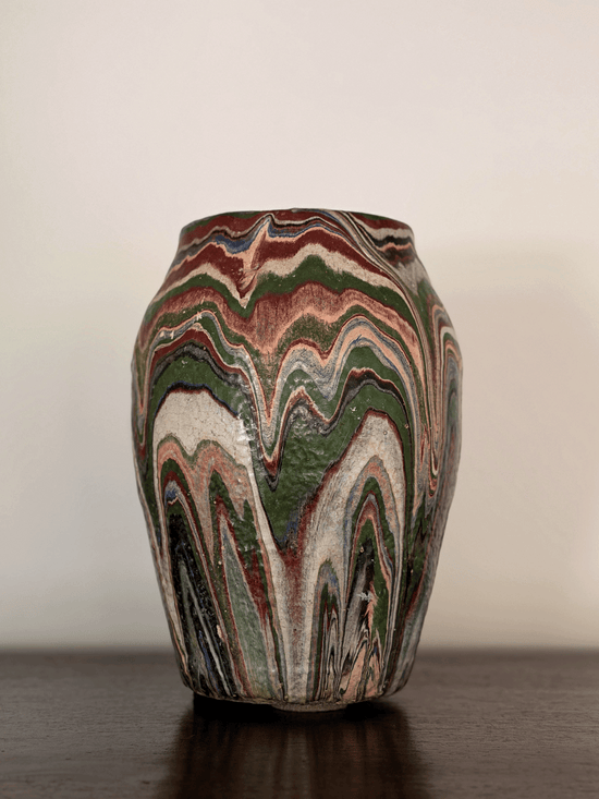 Imposing front-view photo of a large 10-inch tall antique Ozark tourist pottery vase featuring heavy, textured, flame-like wavy swirls of blue, rust, green, and cream paint.