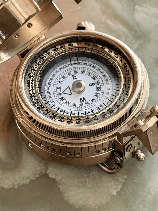 Close up of face on vintage reproduction circular brass military prismatic sighting compass