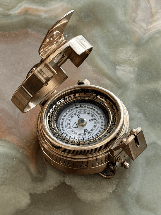 Close up of face on vintage reproduction circular brass military prismatic sighting compass
