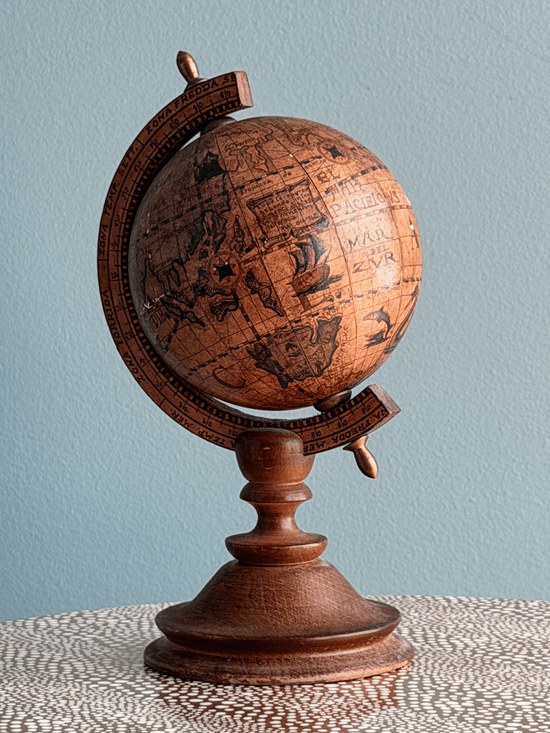 Vintage 1960s Italian desktop world globe by Zoffoli, featuring an antiqued 16th-century style paper map reproduction on a turned dark walnut solid wood pedestal stand and a wooden meridian arc.