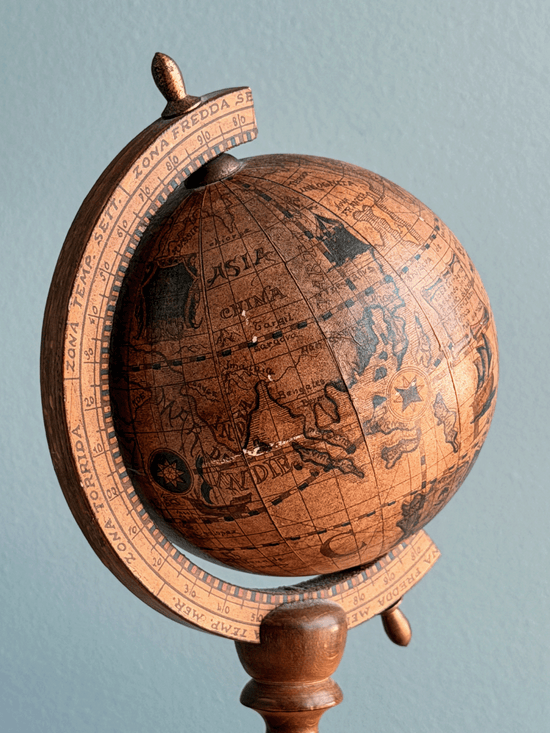 Vintage 1960s Italian desktop world globe by Zoffoli, featuring an antiqued 16th-century style paper map reproduction on a turned dark walnut solid wood pedestal stand and a wooden meridian arc.