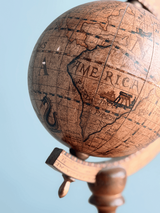 Close-up of a vintage Zoffoli Italian globe map showing South America labeled as AMERICA and PAMPA, detailed with an illustrated multi-masted galleon ship and a coiled sea monster in the Atlantic Ocean.