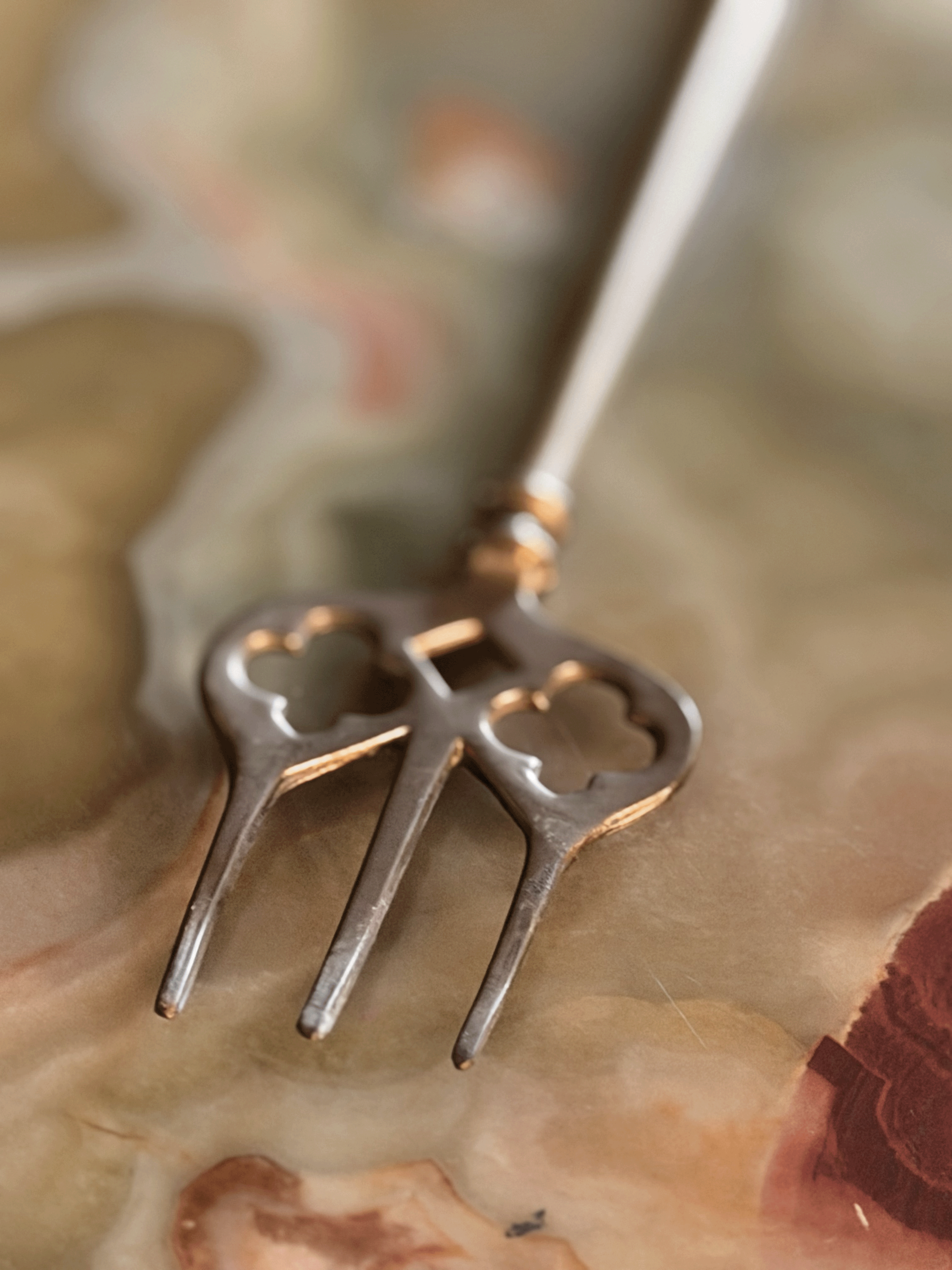 Prongs at end of toasting fork with geometric cut-outs for detail