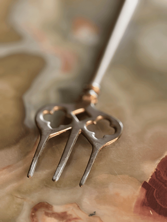 Prongs at end of toasting fork with geometric cut-outs for detail